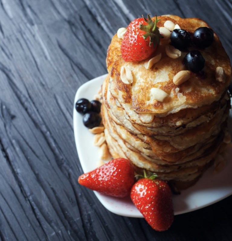 Super healthy protein pancake stack with berries and nuts